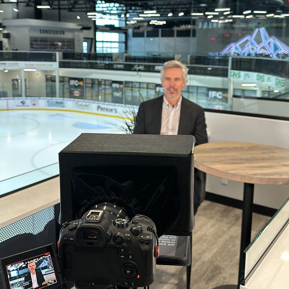 Dr. Martin Mrazik recording The EAS Podcast rinkside